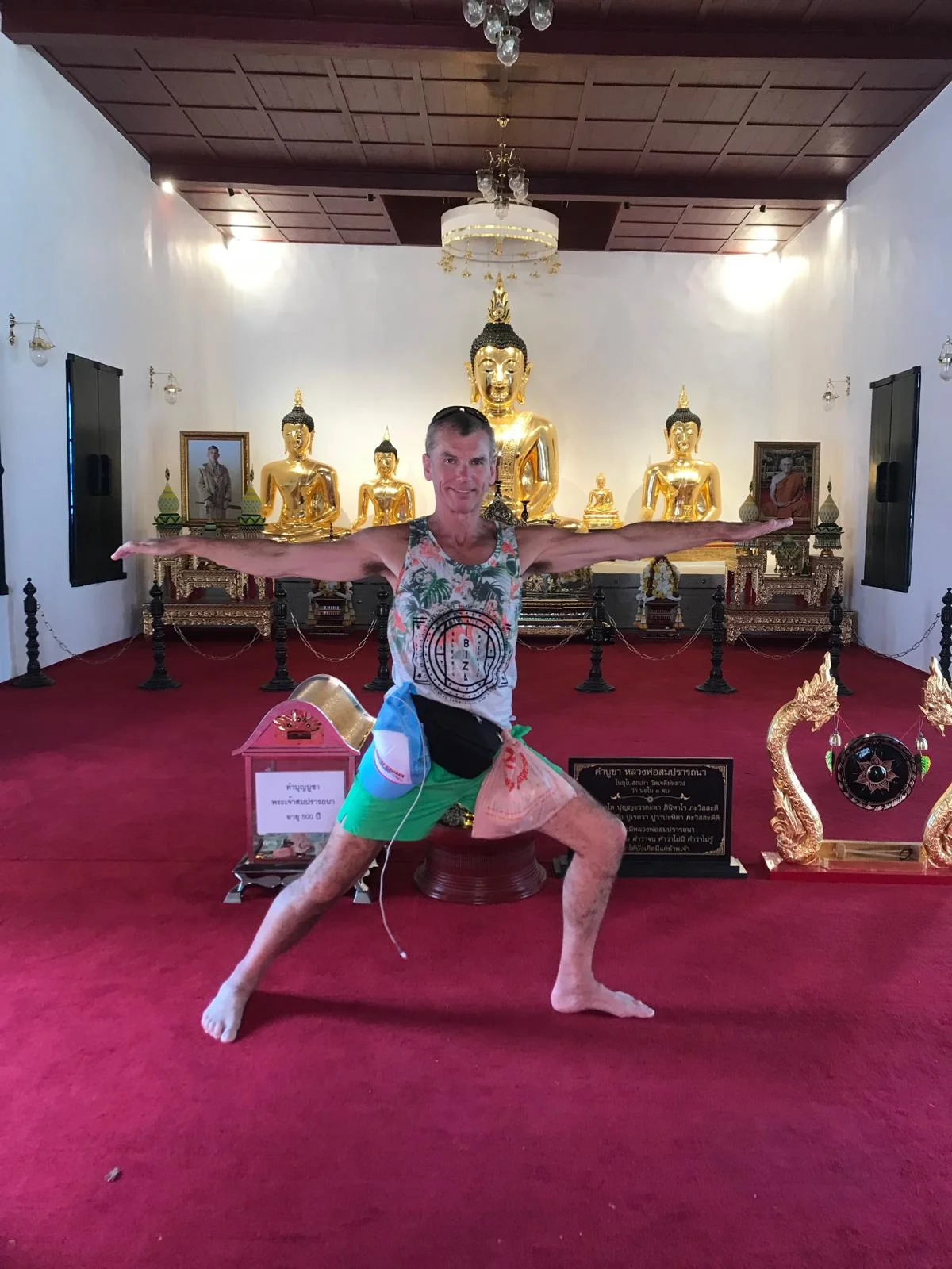 Mark Bell practising a warrior pose inside a golden temple